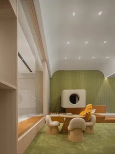 Modern minimalist children's playroom with wood furniture and green carpet, featuring a playful wooden structure with a圆形开口和柔