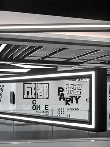A black and white minimalist signage panel with bold text on a sleek, modern interior wall.
