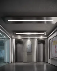 Modern office lobby with metallic walls and ceiling lights.