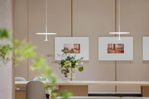 A modern office space featuring wall art with photographs of urban landscapes.