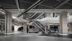 Lobby area in a modern shopping mall with concrete, glass, and steel materials.