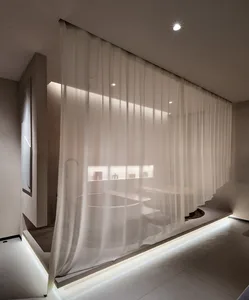 Modern bathroom interior featuring transparent curtains and minimalist design.