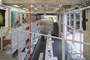 Industrial retail space featuring metallic shelves with various items displayed.