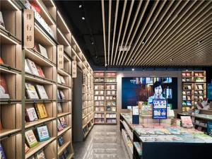 A modern bookstore with shelves filled with books, illuminated by bright lights.
