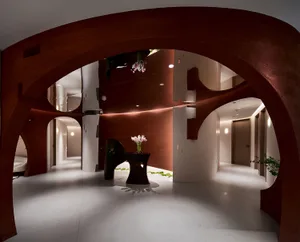 A modern interior space featuring concrete walls, floors, and furniture.