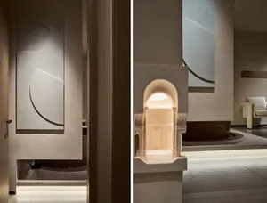 Modern minimalist lobby with illuminated architectural details and glass panels.