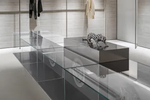 Modern retail display featuring a metal sculpture of a leopard on a high platform.