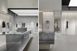 A modern retail interior with glass displays, concrete surfaces, and metal accents.