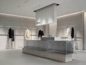 Modern retail store with a glass counter displaying clothing and accessories.