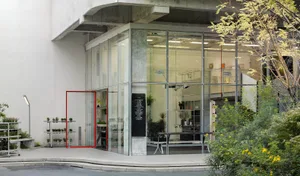 Modern storefront featuring glass and concrete materials.