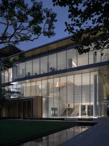 A modern office building exterior made of glass and concrete.