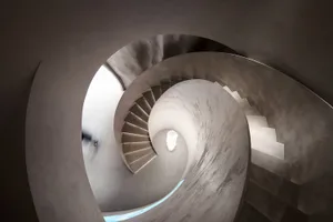 A modern concrete staircase with curved steps.