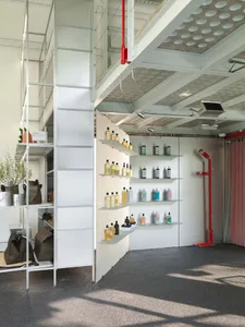 Modern storefront featuring metal shelves and concrete flooring showcasing organic products.