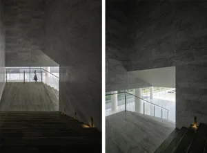 A modern staircase with concrete tiles and white columns