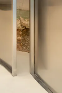 A modern interior space featuring a glass wall, showcasing contemporary design.