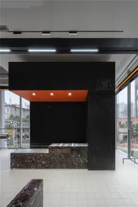 Modern lobby featuring a marble wall and floor