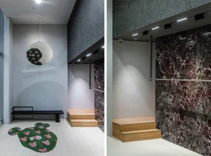A modern lobby featuring marble, concrete, and wooden elements.