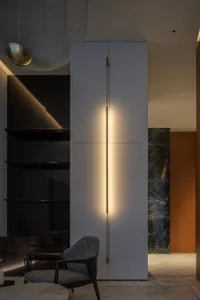 A modern minimalist living room featuring polished marble flooring and sleek, white furniture.