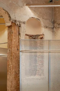 Construction repair of a wall with metal and concrete materials.