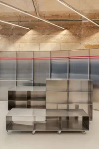Industrial-style metal storage solution with multiple shelves on wheels.