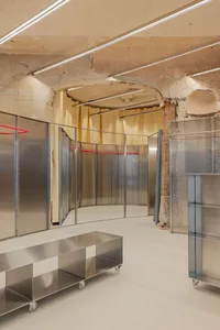 A modern, industrial storefront composed of metallic surfaces and minimalist design.