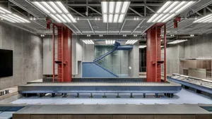 Industrial-style office space with concrete, glass, and steel materials.