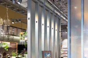Metal storefront with industrial lighting and hanging baskets