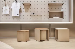 A minimalist retail storefront with wooden furniture and shelves.