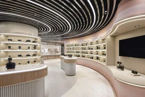 Modern camera store featuring light wood, concrete, and curved panels