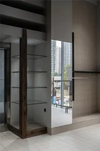 Interior view of a modern storefront with glass walls and open shelving.