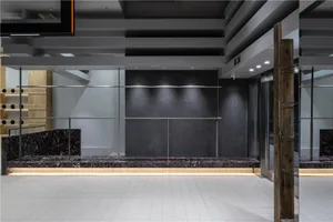 A modern interior space featuring a black marble wall and floor.