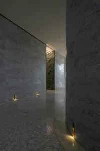 Modern interior with a corridor featuring a moody lighting setup.