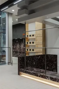 A modern interior featuring marble and wood elements.