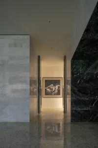 A serene, minimalist corridor featuring black and white marble walls.