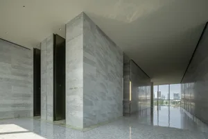 A modern marble lobby interior with minimalist design and sleek, polished finishes.