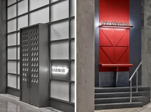 Modern storefront with metallic doors and glass panels.