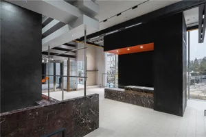 An image showcasing a modern office space featuring marble and concrete materials.