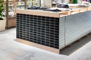 A modern retail display featuring a metal grid structure and industrial finishes, showcasing organized and structured present