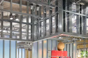 Modern retail space on the ground floor featuring glass panels and metal framing.