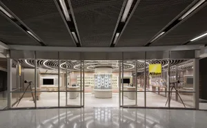 Modern retail storefront with glass walls and marble flooring.
