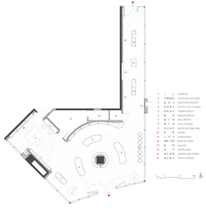 Layout of a retail store with tiled and concrete flooring, showing various functional zones such as a reception counter, came