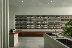 Minimalist retail storefront featuring concrete shelves and sinks