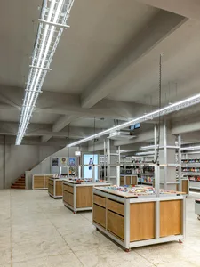 A modern industrial retail store featuring wooden display tables and metal shelving units.