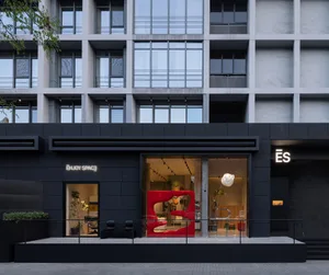 Modern retail storefront with black, concrete, minimalist design.