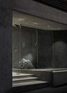 Concrete and glass installation art with lighting accents.