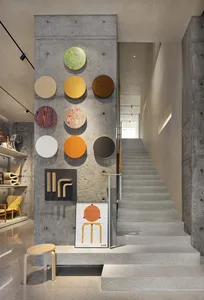 A modern staircase with a display of colorful concrete panels.