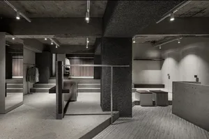 Modern retail store with concrete finishes and industrial design elements.