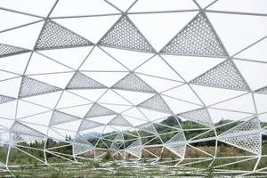 A large, white metal structure with a triangular pattern.