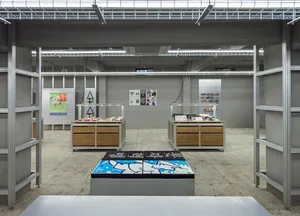 Industrial retail space with metal shelves, wood displays, and products on the shelves.