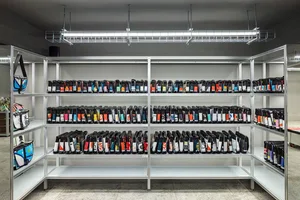 Metal shelving units filled with bags in a row.